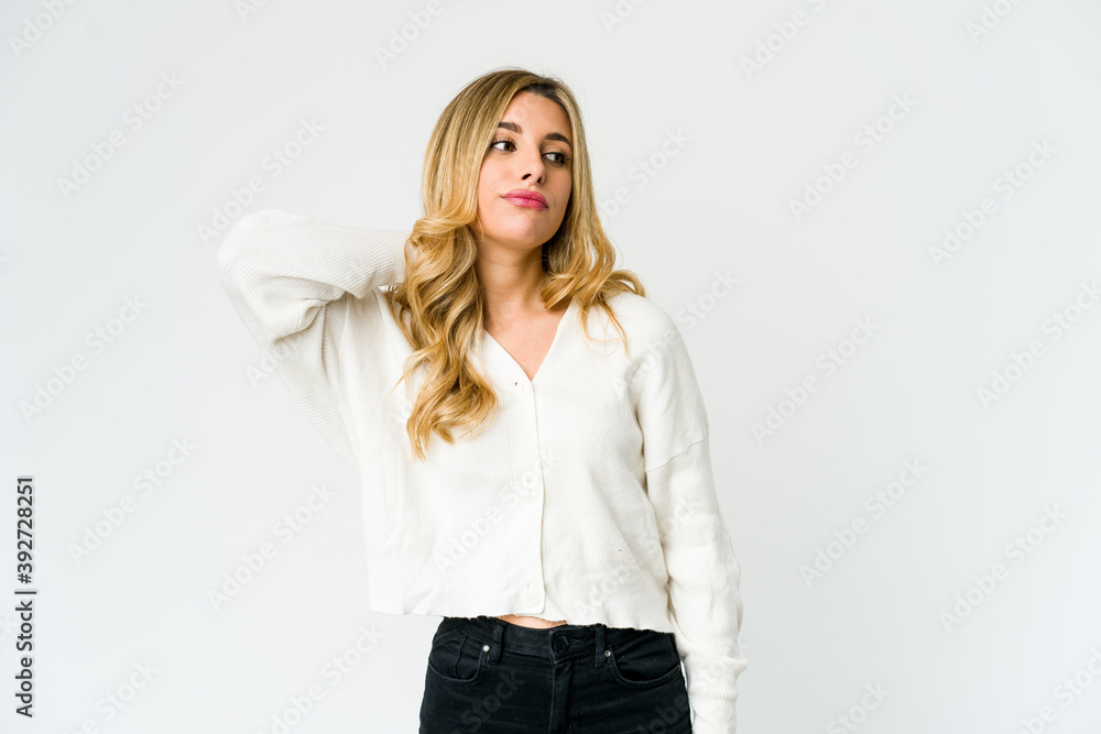 Young caucasian blonde woman touching back of head, thinking and making a choice. Young caucasian blonde woman touching back of head, thinking and making a choice.