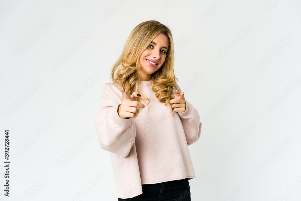 Young caucasian blonde woman pointing to front with fingers. Young caucasian blonde woman pointing to front with fingers.