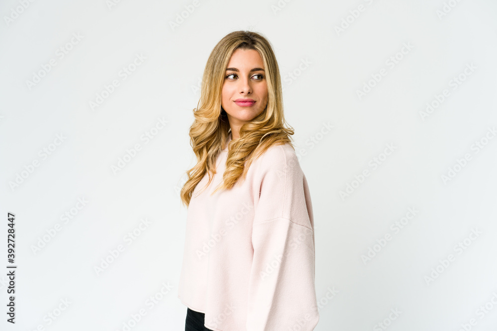 Young caucasian blonde woman looks aside smiling, cheerful and pleasant. Young caucasian blonde woman looks aside smiling, cheerful and pleasant.