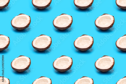 Half a coconut on blue background. Seamless pattern.
