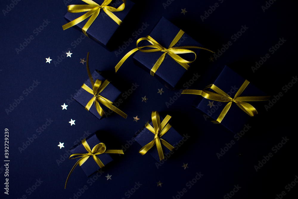 Navy blue gifts with gold ribbons.Set of gift box isolated on navy blue background.Christmas gift boxes on black background. Merry Christmas and Happy Holidays greeting card, frame, banner. Navy blue gifts with gold ribbons.Set of gift box isolated on navy blue background.Christmas gift boxes on black background. Merry Christmas and Happy Holidays greeting card, frame, banner.