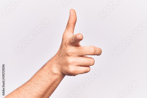 Close up of hand of young caucasian man over isolated background pointing forefinger to the camera, choosing and indicating towards direction © Krakenimages.com