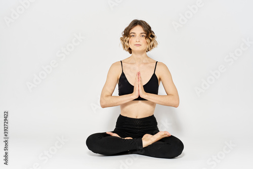 woman in dark clothes sitting on the floor and meditation exercises for legs leggings