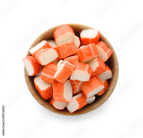 Tableau sur toile Cut crab sticks in bowl on white background, top view