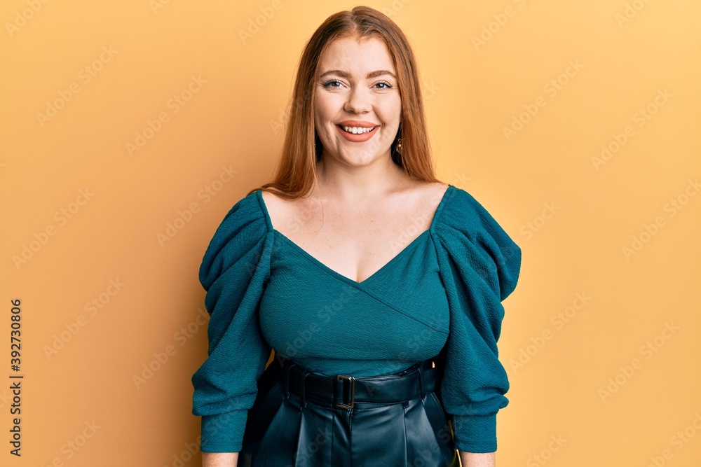 Young beautiful redhead woman wearing elegant and sexy look with a happy and cool smile on face. lucky person. Young beautiful redhead woman wearing elegant and sexy look with a happy and cool smile on face. lucky person.