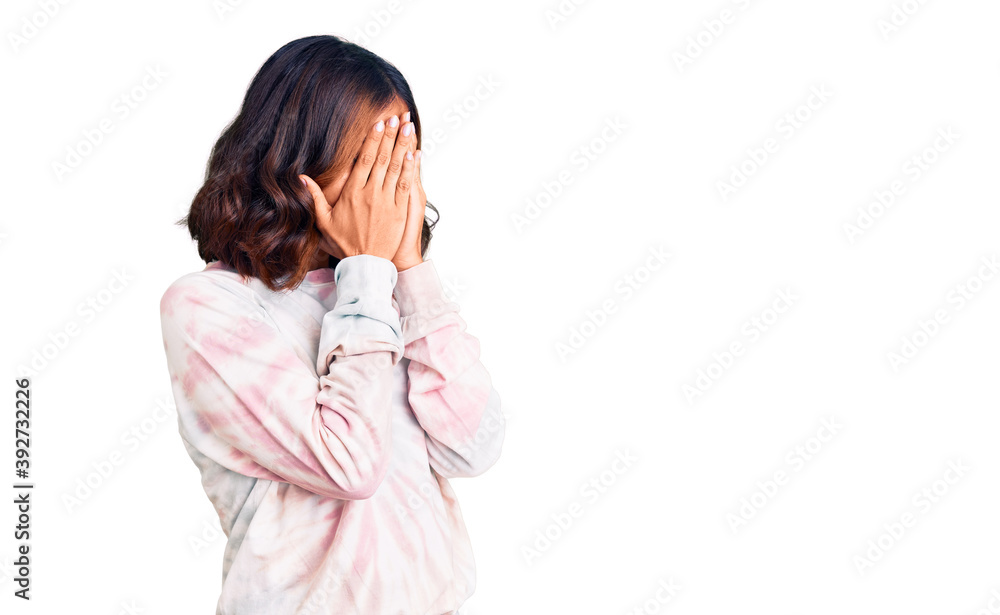 Young beautiful mixed race woman wearing casual tie dye sweatshirt with sad expression covering face with hands while crying. depression concept. Young beautiful mixed race woman wearing casual tie dye sweatshirt with sad expression covering face with hands while crying. depression concept.