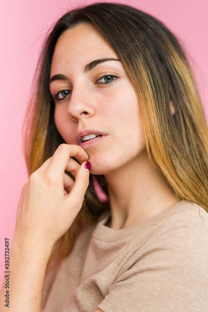 Young beautiful woman isolated on pink background