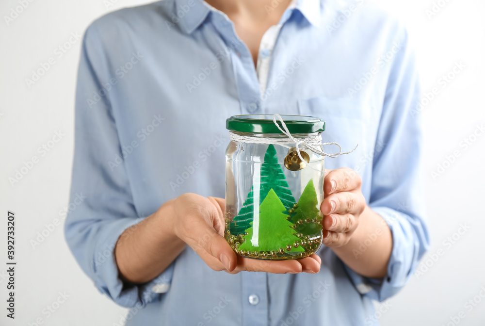 Woman holding handmade snow globe on white background, closeup Woman holding handmade snow globe on white background, closeup