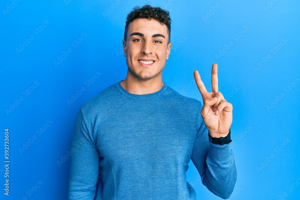 Handsome young man wearing casual clothes very happy and excited doing winner gesture with arms raised, smiling and screaming for success. celebration concept. Handsome young man wearing casual clothes very happy and excited doing winner gesture with arms raised, smiling and screaming for success. celebration concept.
