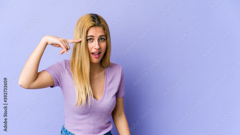 Young blonde caucasian woman showing a disappointment gesture with forefinger. Young blonde caucasian woman showing a disappointment gesture with forefinger.