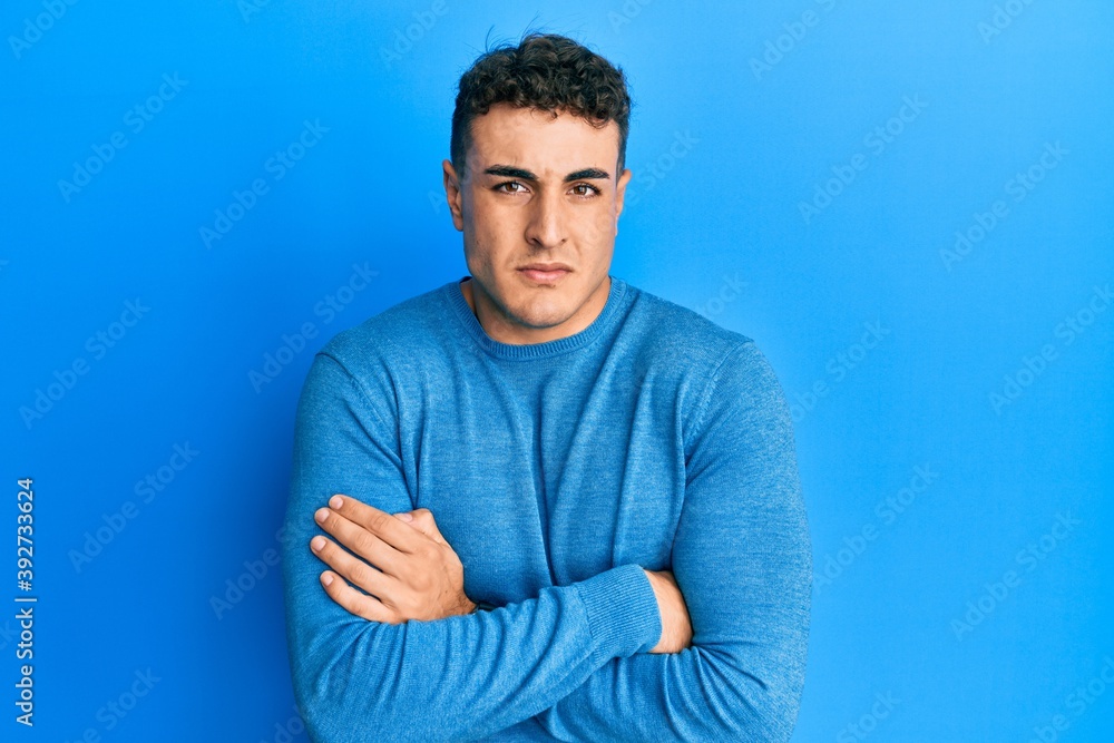 Handsome young man wearing casual clothes sleeping tired dreaming and posing with hands together while smiling with closed eyes. Handsome young man wearing casual clothes sleeping tired dreaming and posing with hands together while smiling with closed eyes.