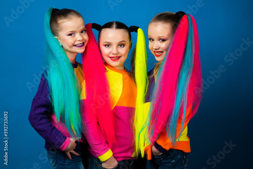 Group of Colorful dressed kids portrait. Funny excited little girls. Friendship, fashionable concept. Kids fashion.