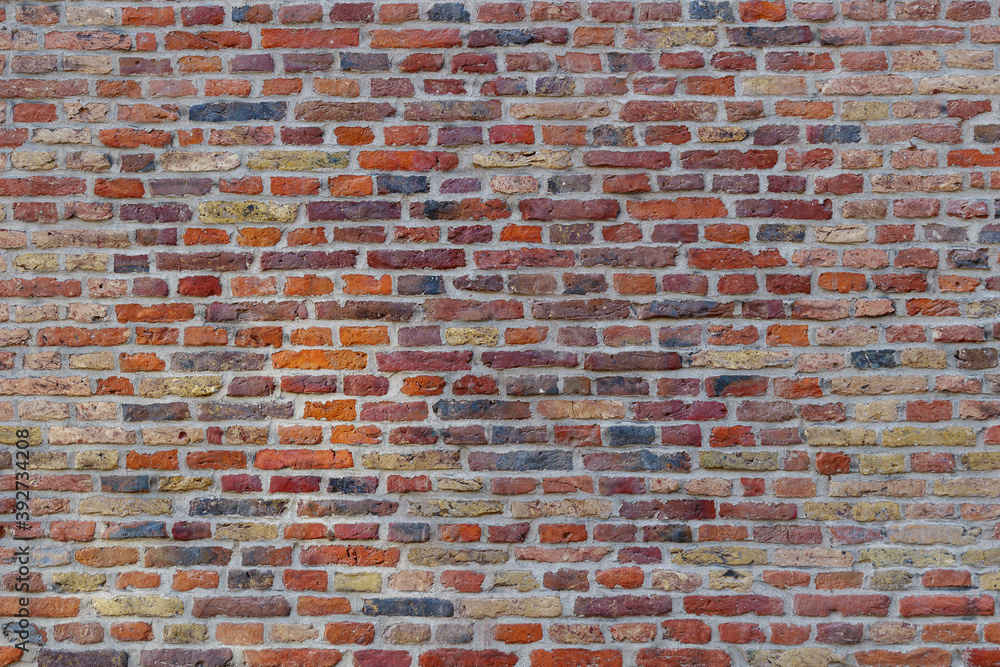Naklejka premium Real vintage Bumpy, rough and old brick texture with imperfect, dilapidate, impair, corroded and defective English brick bond pattern.