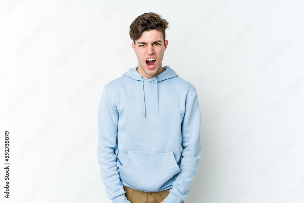 Fototapeta premium Young caucasian man isolated on white background shouting very angry, rage concept, frustrated.