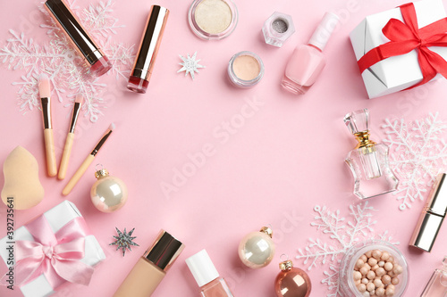 Frame of decorative cosmetic products on pink background, flat lay with space for text. Winter care