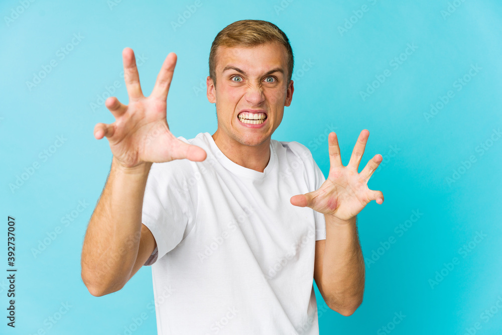 Young caucasian handsome man upset screaming with tense hands. Young caucasian handsome man upset screaming with tense hands.