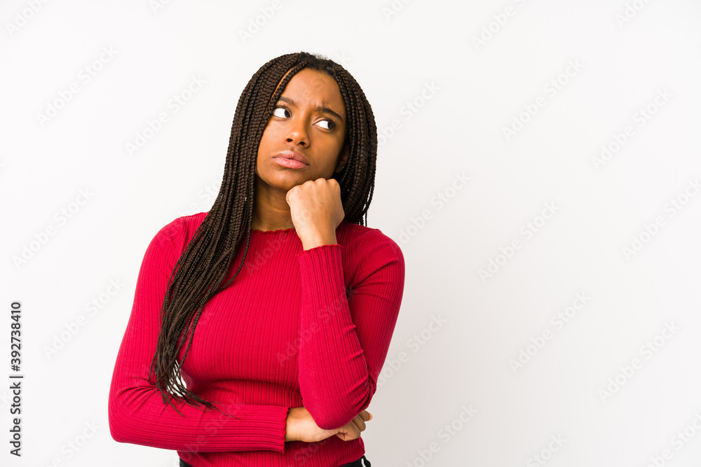Young african american woman isolated who feels sad and pensive, looking at copy space. Young african american woman isolated who feels sad and pensive, looking at copy space.