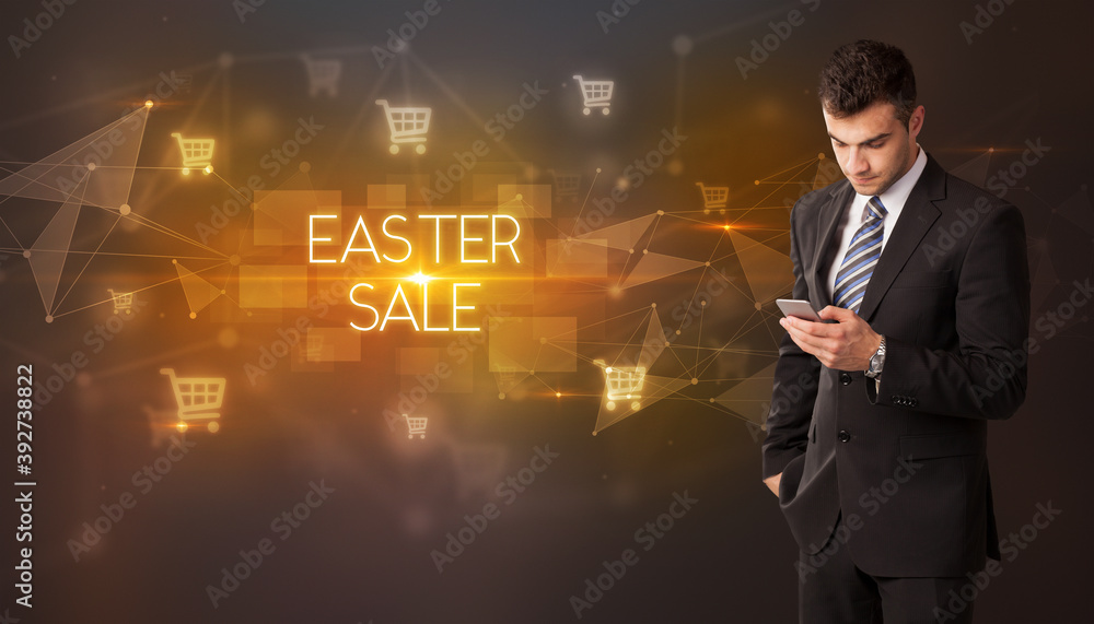 Businessman with shopping cart icons and EASTER SALE inscription, online shopping concept Businessman with shopping cart icons and EASTER SALE inscription, online shopping concept