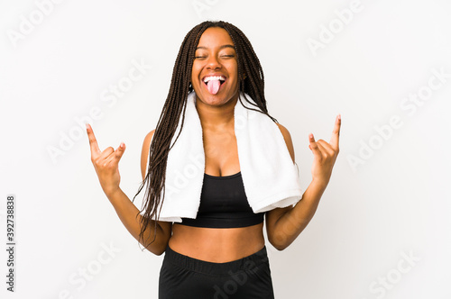 Young african american sport woman isolated showing rock gesture with fingers © Asier