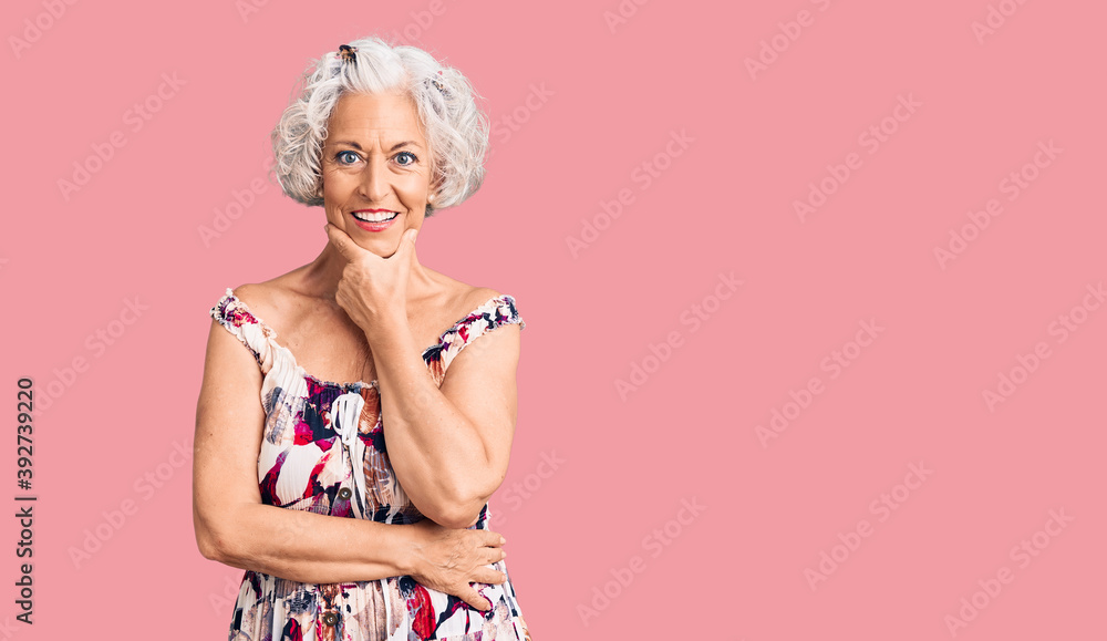 Senior grey-haired woman wearing casual clothes looking confident at the camera smiling with crossed arms and hand raised on chin. thinking positive. Senior grey-haired woman wearing casual clothes looking confident at the camera smiling with crossed arms and hand raised on chin. thinking positive.