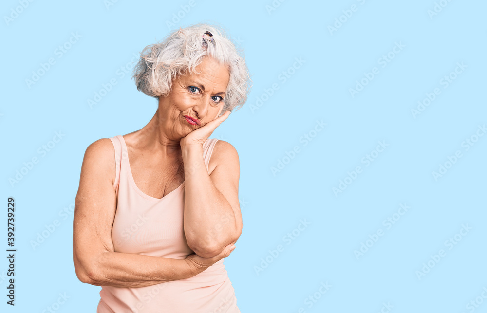 Senior grey-haired woman wearing casual clothes thinking looking tired and bored with depression problems with crossed arms.