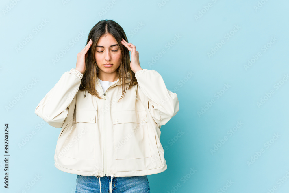 Young caucasian woman touching temples and having headache.