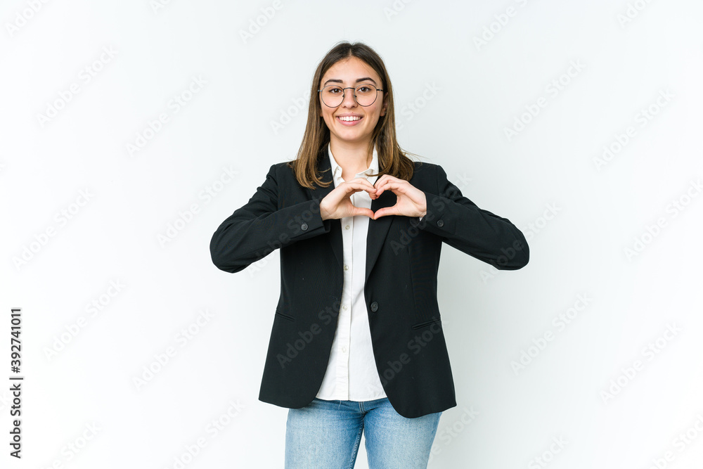 Young caucasian business woman smiling and showing a heart shape with hands. Young caucasian business woman smiling and showing a heart shape with hands.