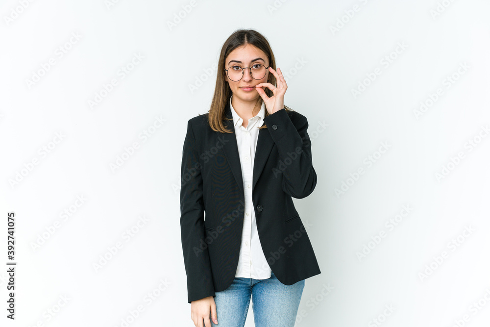 Young caucasian business woman with fingers on lips keeping a secret. Young caucasian business woman with fingers on lips keeping a secret.