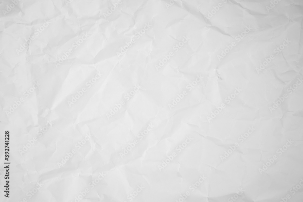 white and gray crumpled paper texture background. crush paper so that it becomes creased and wrinkled.