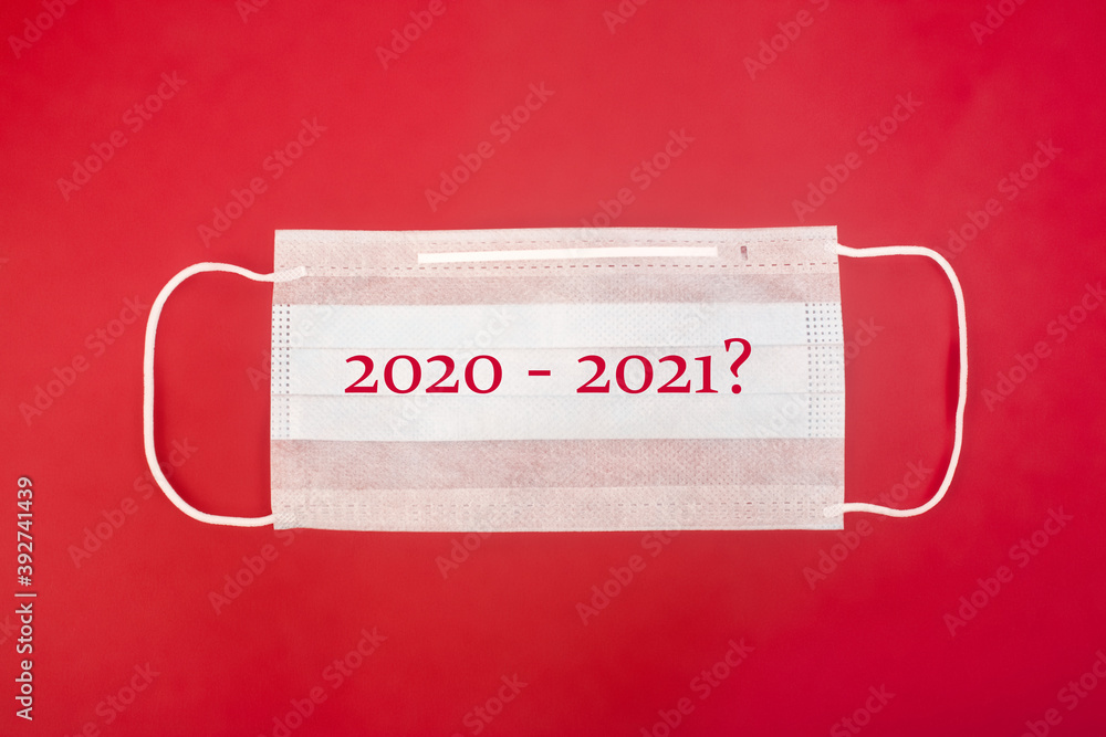 medical mask with figures 2020 2021? on a red background top view medical mask with figures 2020 2021? on a red background top view