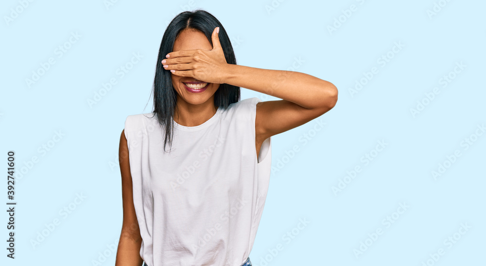 Young african american woman wearing casual clothes smiling and laughing with hand on face covering eyes for surprise. blind concept. Young african american woman wearing casual clothes smiling and laughing with hand on face covering eyes for surprise. blind concept.