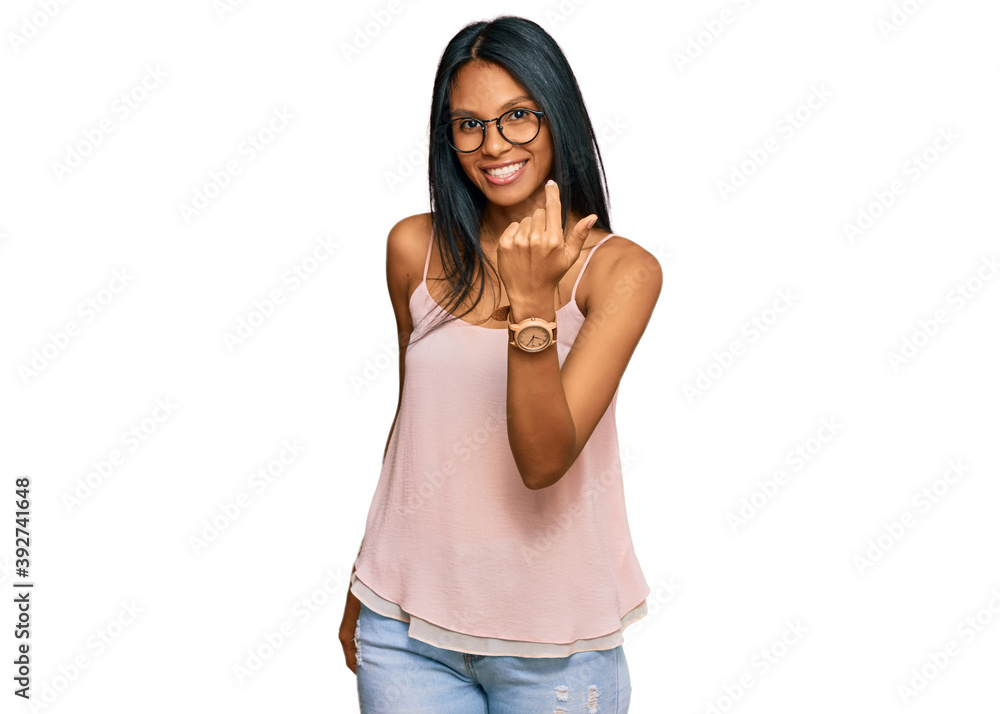 Young african american woman wearing casual clothes and glasses beckoning come here gesture with hand inviting welcoming happy and smiling Young african american woman wearing casual clothes and glasses beckoning come here gesture with hand inviting welcoming happy and smiling