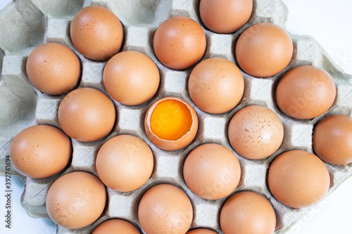 Top view, fresh chicken eggs isolated on a white background. Chicken egg is half broken among other eggs.