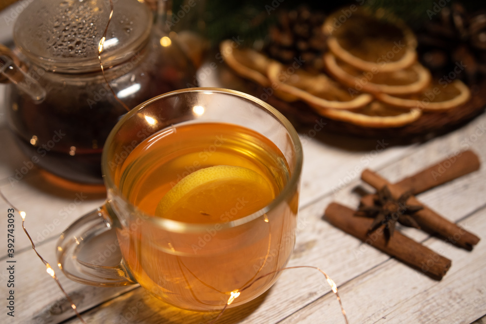 a cup of hot Christmas tea with lemon on a light wood. against the background of an asterisk star anise, an orange and a sprig of a Christmas tree. christmas concept
a cup of hot Christmas tea with lemon on a light wood. against the background of an asterisk star anise, an orange and a sprig of a Christmas tree. christmas concept