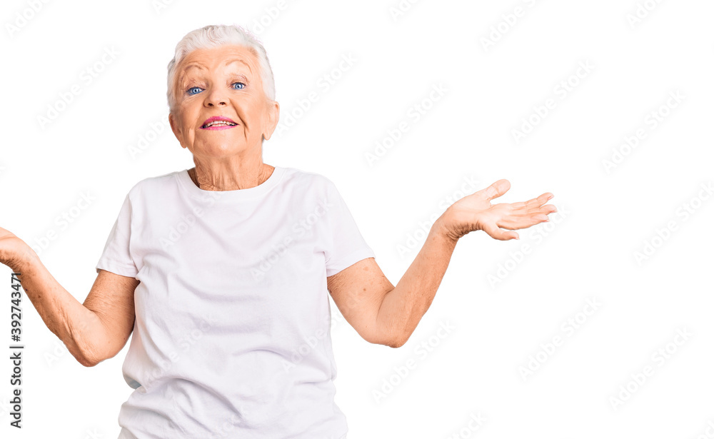Senior beautiful woman with blue eyes and grey hair wearing casual white tshirt smiling showing both hands open palms, presenting and advertising comparison and balance Senior beautiful woman with blue eyes and grey hair wearing casual white tshirt smiling showing both hands open palms, presenting and advertising comparison and balance