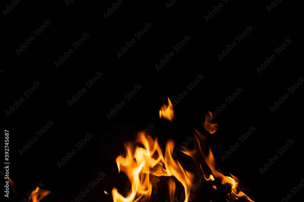 Fototapeta premium Fire flames on black background. fire burst texture for banner backdrop.