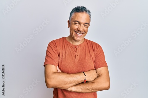 Handsome middle age mature man wearing casual clothes happy face smiling with crossed arms looking at the camera. positive person.