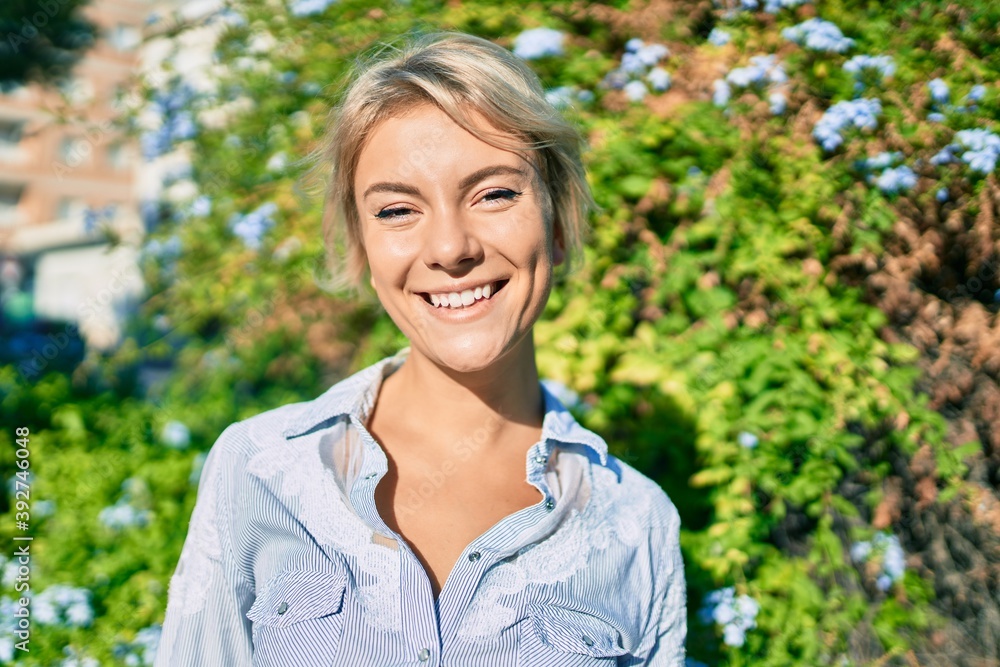 Young blonde woman smiling happy walking at the park. Young blonde woman smiling happy walking at the park.