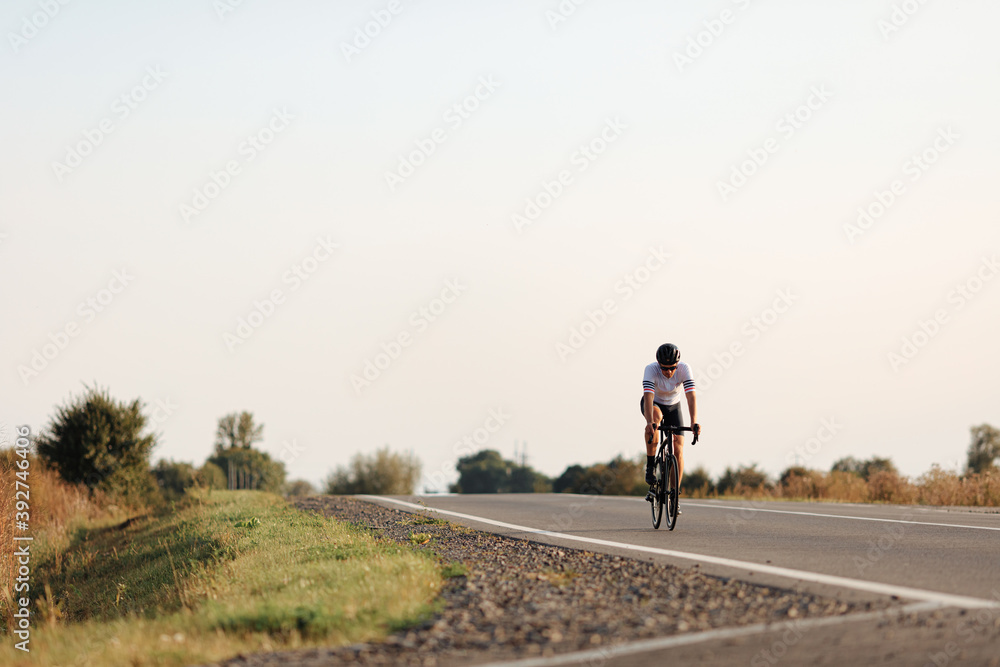 Muscular man in helmet having long distance ride Muscular man in helmet having long distance ride