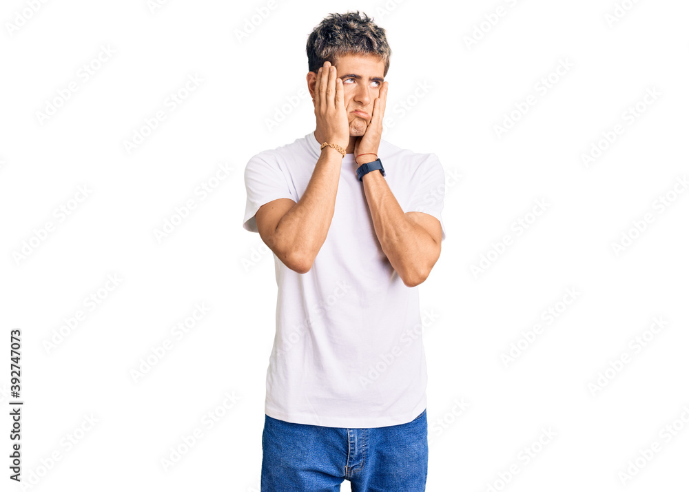 Young handsome man wearing casual white tshirt tired hands covering face, depression and sadness, upset and irritated for problem Young handsome man wearing casual white tshirt tired hands covering face, depression and sadness, upset and irritated for problem