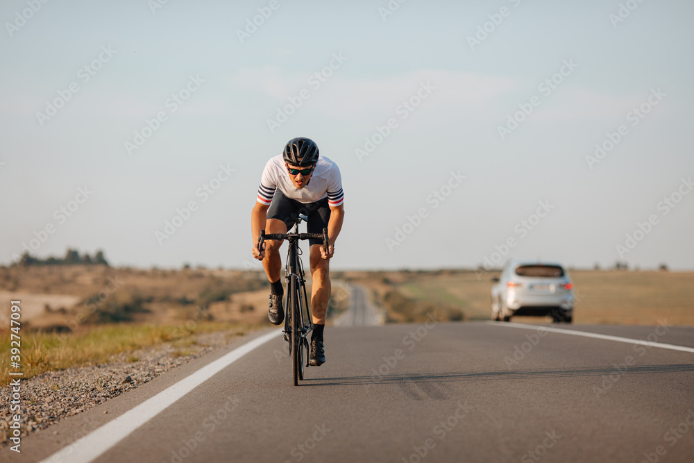 Obraz premium Professional cyclist racing on asphalt road