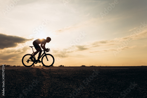 Fototapeta Naklejka Na Ścianę i Meble -  Side view of sportsman in protective helmet riding bike