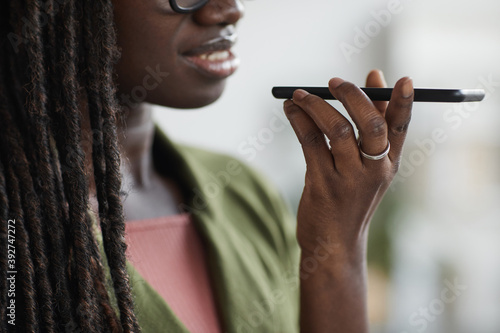 Fényképezés Close up portrait of stylish young African woman recording voice message via sma