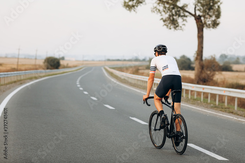 Back view of active man riding bike on fresh air © Tymoshchuk