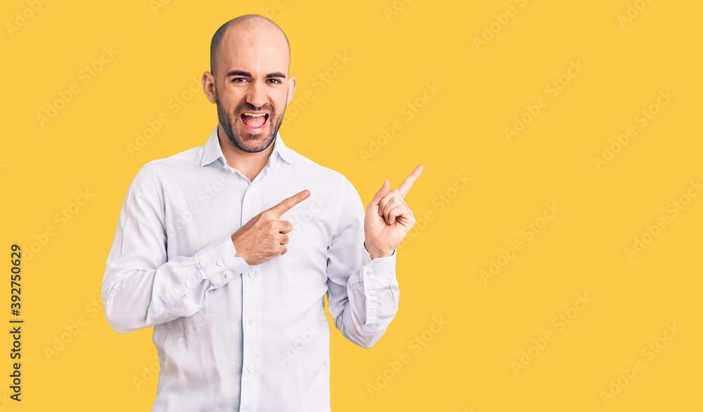 Young handsome man wearing elegant shirt smiling and looking at the camera pointing with two hands and fingers to the side. Young handsome man wearing elegant shirt smiling and looking at the camera pointing with two hands and fingers to the side.