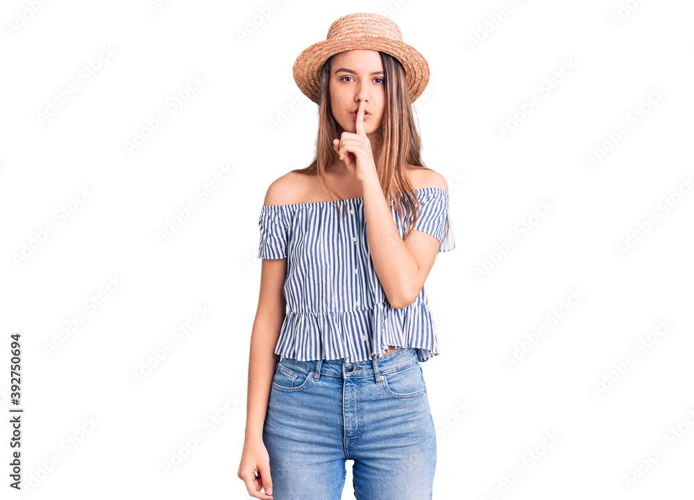 Young beautiful girl wearing hat and t shirt asking to be quiet with finger on lips. silence and secret concept. Young beautiful girl wearing hat and t shirt asking to be quiet with finger on lips. silence and secret concept.
