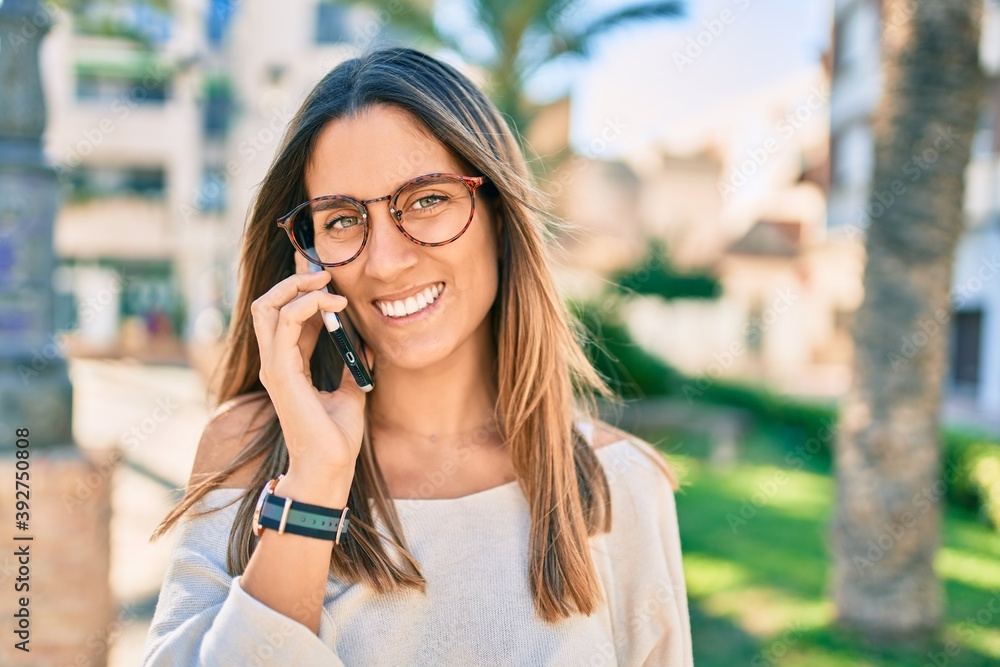 Young caucasian woman smiling happy talking on the smartphone at the park. Young caucasian woman smiling happy talking on the smartphone at the park.