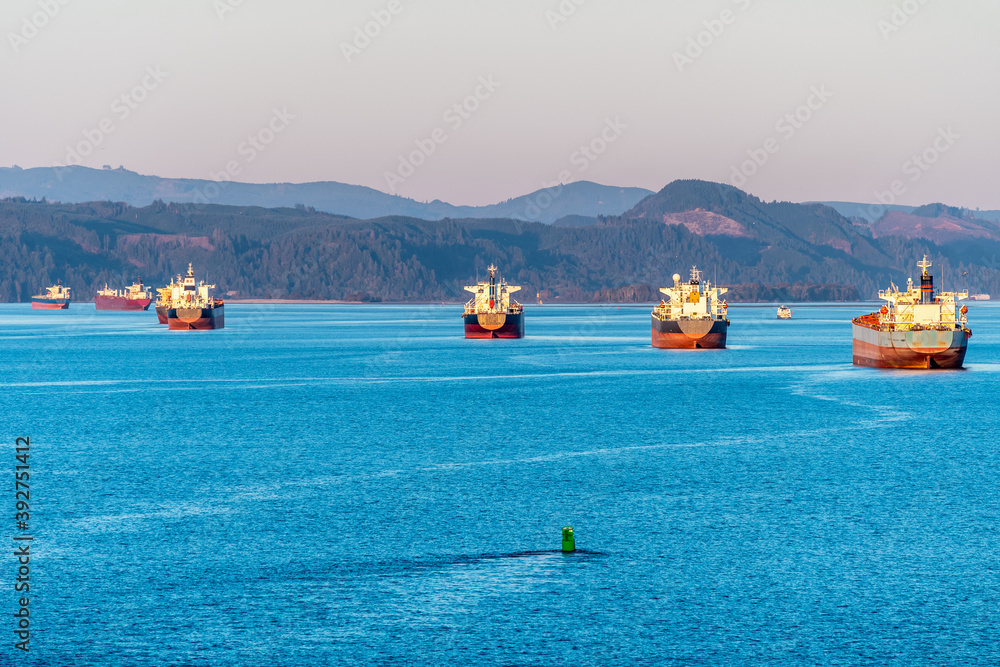 Fleet of cargo ships sailing ocean. Container nautical vessels with shipment of export goods making supply chain delivery. Merchant tankers transport bulk freight for commerce and trade across the sea