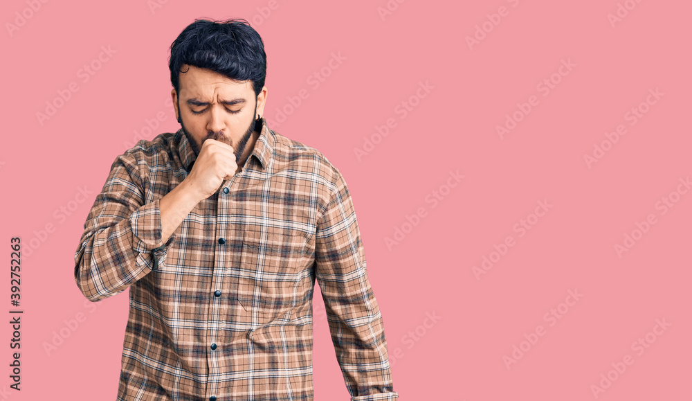 Fototapeta premium Young hispanic man wearing casual clothes feeling unwell and coughing as symptom for cold or bronchitis. health care concept.