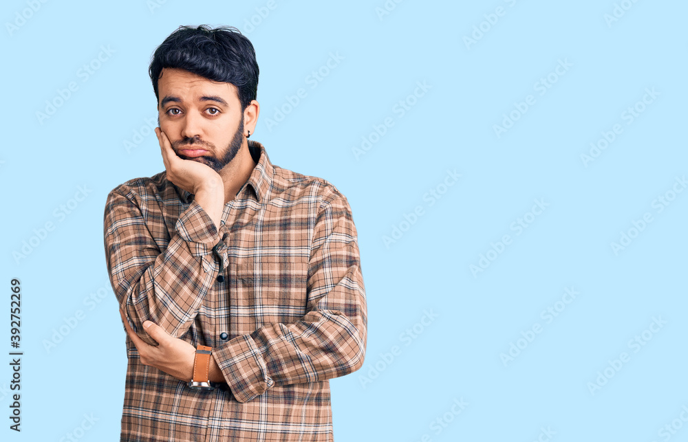 Young hispanic man wearing casual clothes thinking looking tired and bored with depression problems with crossed arms. Young hispanic man wearing casual clothes thinking looking tired and bored with depression problems with crossed arms.